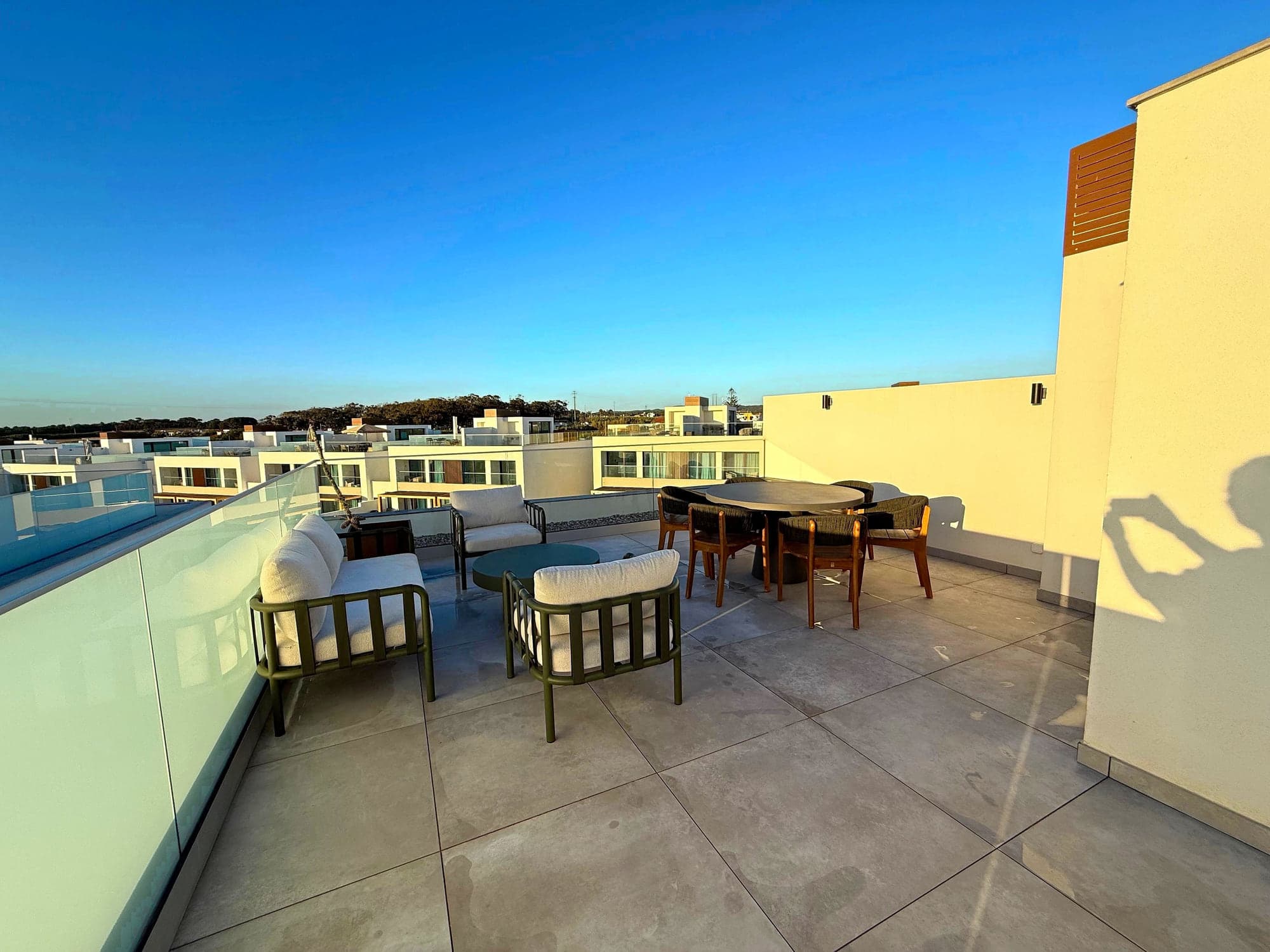 The dining table and outdoor sofas on the private terrace at Blue Cove