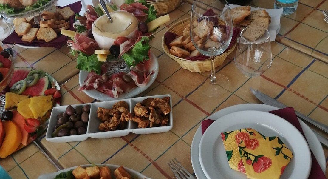 A table of petiscos at Doce Mar: cured meats, cheeses, olives and bread