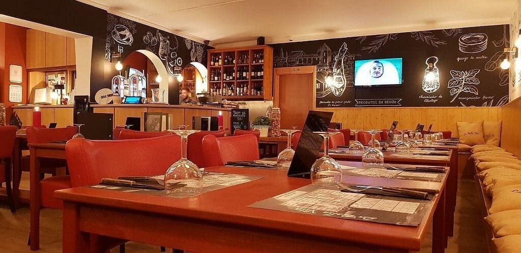 The dining room at La Bella Vita, orange banquettes against a chalkboard wall