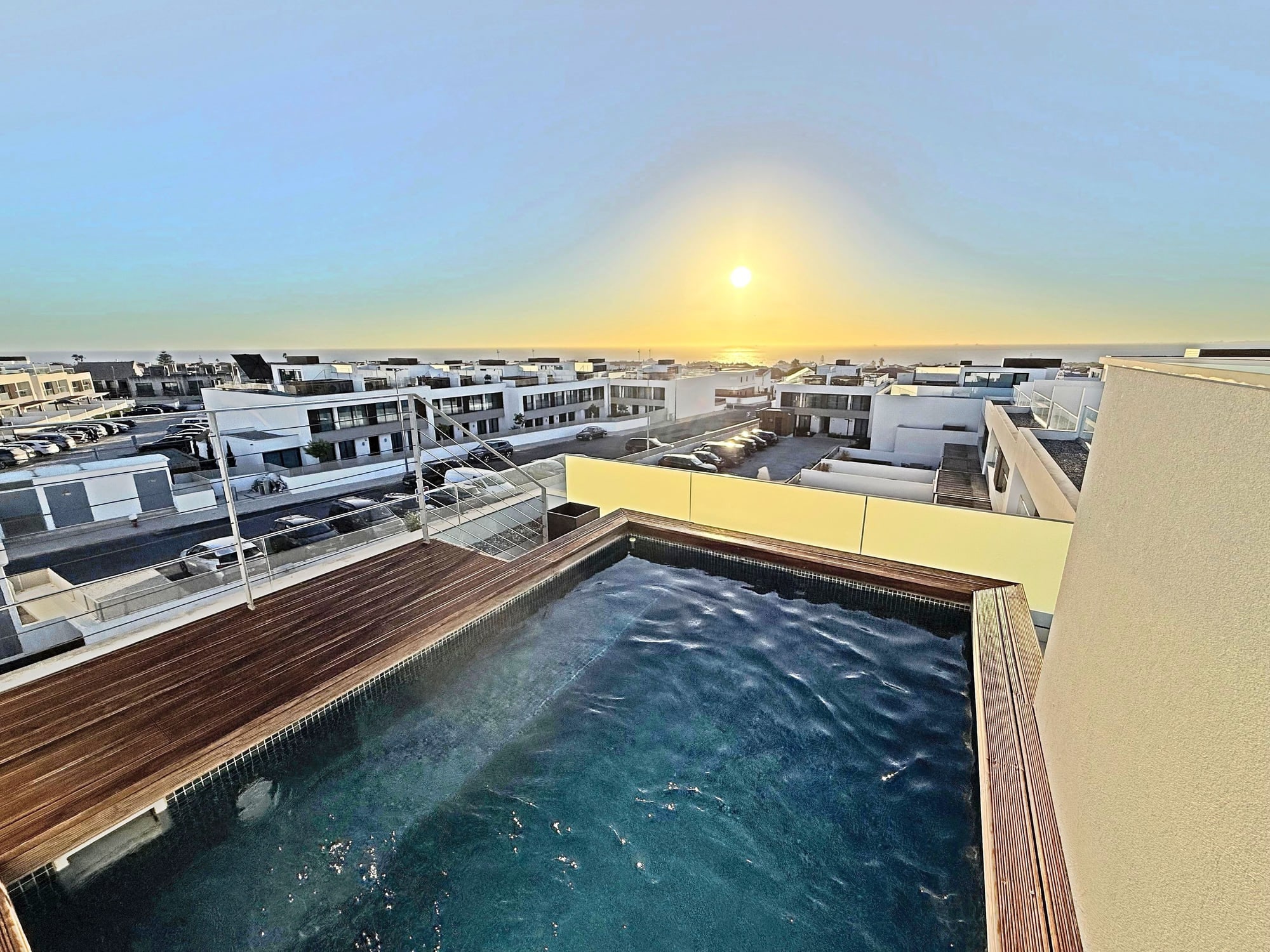 The private pool at Blue Cove with the village rooftops and the Atlantic beyond