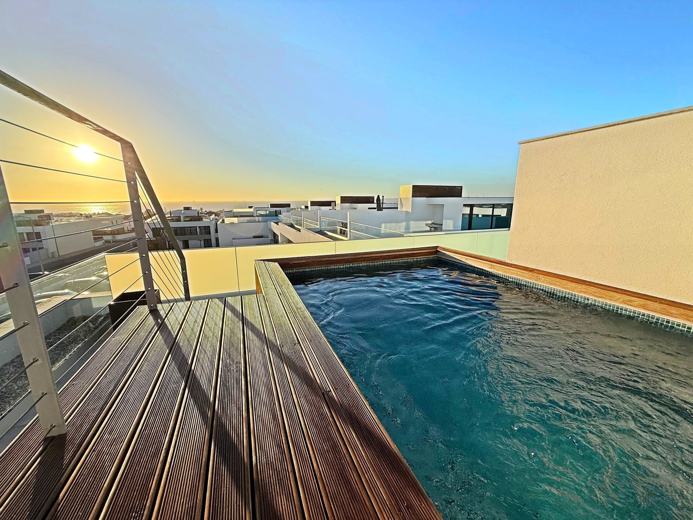 The private heated pool on the terrace at Blue Cove, low sun over the Atlantic behind it