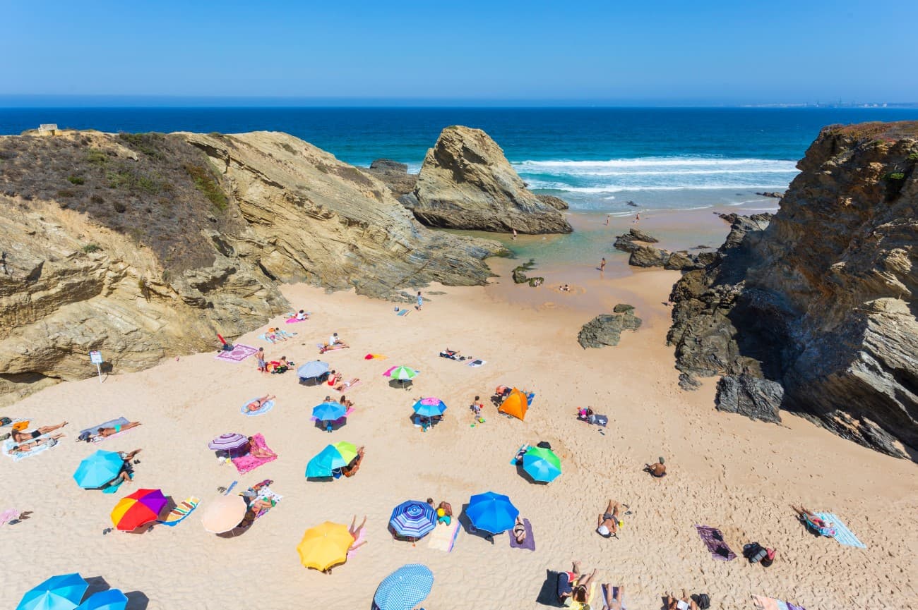 Children playing in the calm sheltered water of Praia do Banho, Porto Covo
